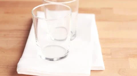 Two empty glasses on a white cloth Stock Footage 24657788