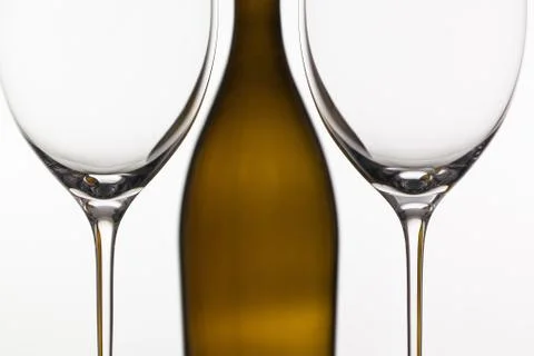 Two empty glasses of wine and brown bottle Stock Photos
