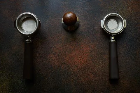 Two empty holders with baskets for single and double espresso and tamper Stock Photos