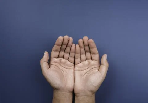 Two empty holding hands gesture isolated on blue background, top view. Giving Stock Photos