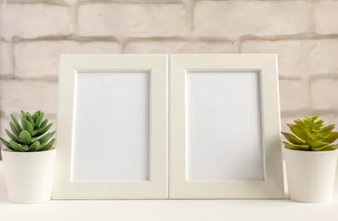 Two empty photo frames on a table or shelf with a copy of the space. Stock Photos