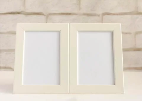 Two empty photo frames on a table or shelf with a copy of the space. Stock Photos