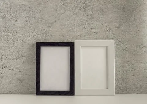 Two empty photo frames on a table or shelf with a copy of the space. Stock Photos