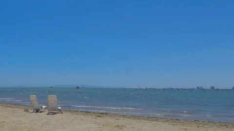 Two Empty Plastic Chairs On The Beach Coastline Stock-Footage 84263474