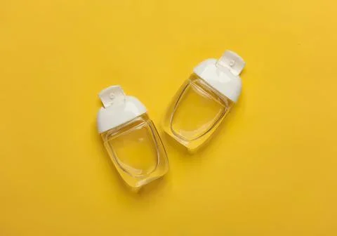 Two empty plastic spray bottles on yellow background Stock Photos