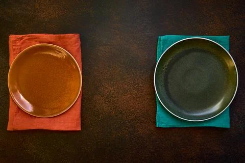 Two empty plates and towels. Grunge backdrop. Top view with copy space. Flat Stock Photos