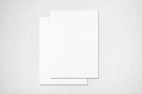 Two empty poster mockups lying on top of each other on grey textured backgrou Stock Photos