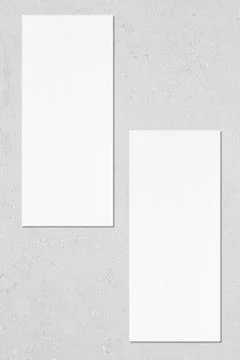 Two empty price-list or menu mockups lying on grey concrete background Stock Photos