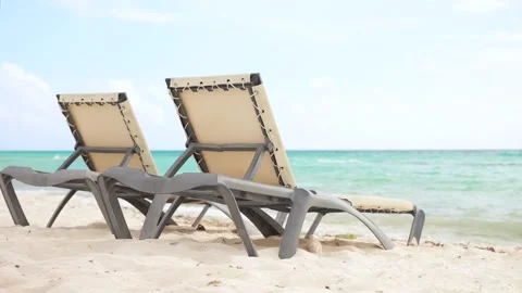 Two empty sun loungers on the sandy beach. Relax and contemplation during summer Stock Footage 270166105