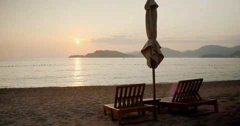 Two empty sunbeds sunset on the sea in Montenegro Stock Footage 123803448