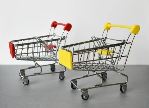 Two empty supermarket carts stand side by side Stock Photos