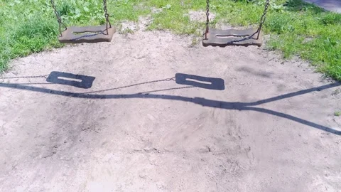 Two empty swing on children playground at public park 库存影片 135580776