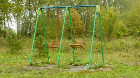 Two empty swing shakes on playground Stock Footage 45178877