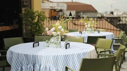 Two empty tables in a restaurant before the arrival of guests on the street Stock Footage 318066040