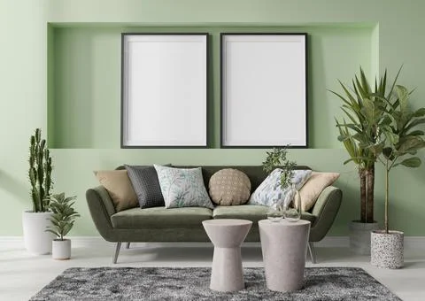 Two empty vertical picture frames on green wall in modern living room. Mock u Stock Photos