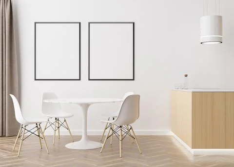 Two empty vertical picture frames on white wall in modern dining room. Mock u Stock Photos