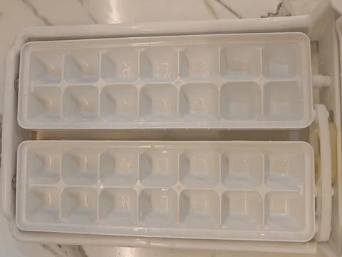 Two Empty White Plastic Ice Cube Trays for Freezer Stock Photos