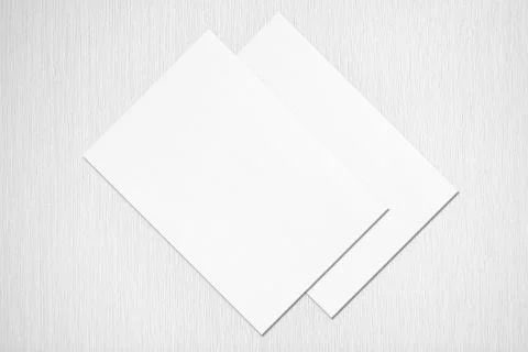 Two empty white poster mockups lying diagonally on grey concrete background Stock Photos