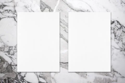 Two empty white vertical rectangle poster mockups on grey marble background Stock Photos
