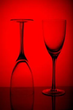 Two Empty wine glasses isolated on red background. Stock Photos