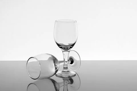 Two empty wine glasses with reflection on background, front view Stock Photos
