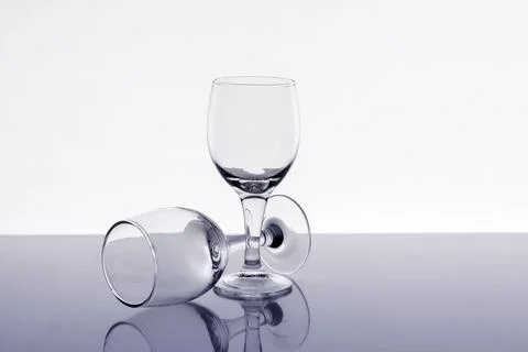 Two empty wine glasses with reflection on background, close up Stock Photos