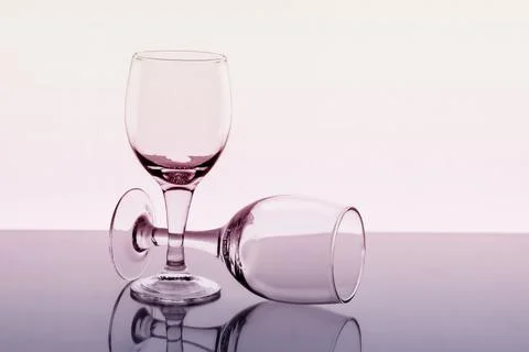 Two empty wine glasses with reflection on background, toned Stock Photos