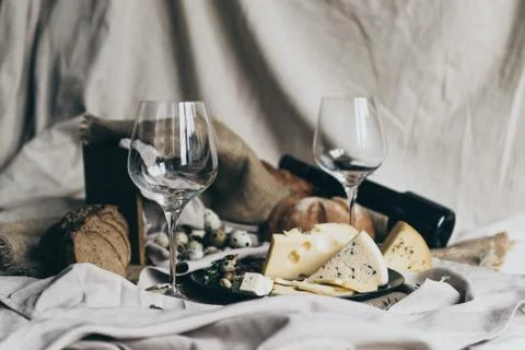 Two empty wineglasses are standing ready to be filled with dry red wine lying Stock Photos