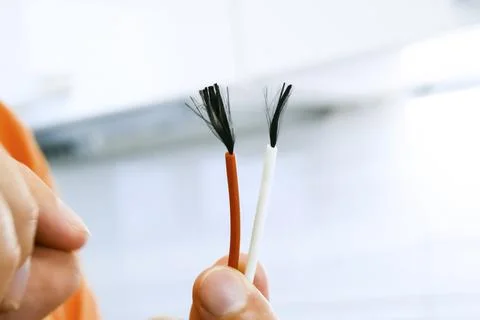 Two ends of bare wire, stripping the contacts. Stock Photos