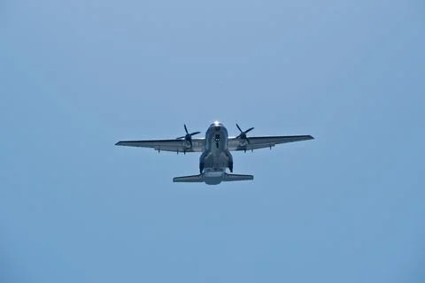 Two-engine airplane in the blue sky. Turboprop transport aircraft Stock Photos