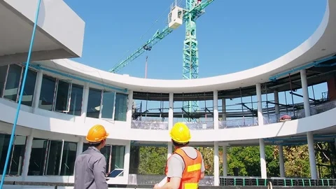Two engineer and architect standing in front of crane on the construction site. Stock Footage 171715847