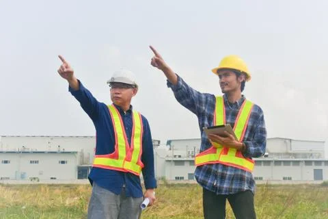 Two engineer construction holding hand to sky success construction building p Stock Photos