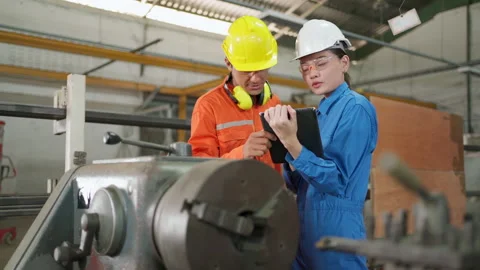 Two engineer control machine in factory Stock Footage 152981997