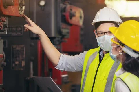 Two engineer in hard hat wearing safety using laptop for planning a project.  Stock Photos