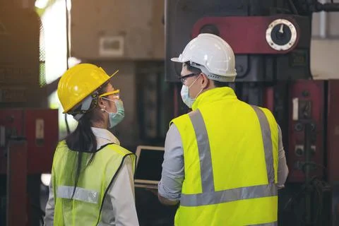 Two engineer in hard hat wearing safety using laptop for planning a project.  Stock Photos