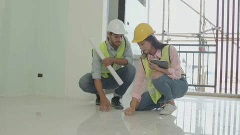 Two engineer inspector knock floor and checking quality Stock Footage 150564120