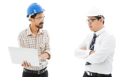 Two Engineer man blue helmet notebook consult Foto stock