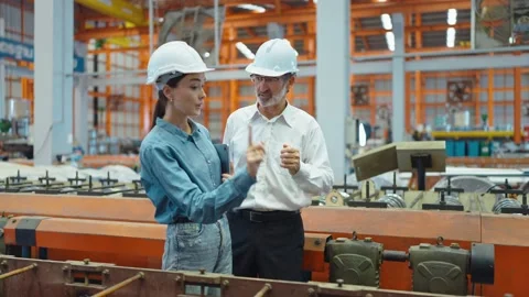Two engineer man, woman manager leader talking and discussing walking in factory 動画素材 237008189