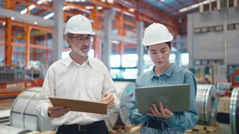Two engineer manager holding laptop talking and walking at manufacturing factory 動画素材 237008729