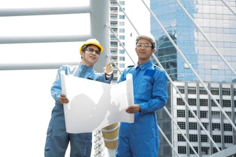 Two Engineer or Architect discuss on Modern Building Project at Constructio.. Stock Photos