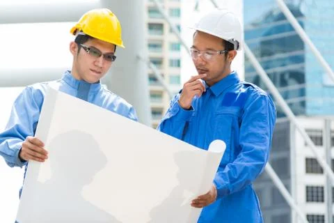 Two Engineer or Architect discuss on Modern Building Project at Constructio.. Stock Photos