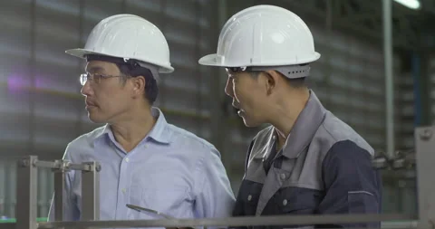 Two engineer talking together at factory. Video stock 169004704