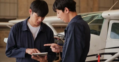 Two engineer using tablet to assist they aircraft project. Video stock 124725140