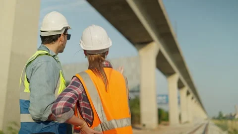 Two engineer using tablet discussion and inspection construction process railway Stock Footage 263021743