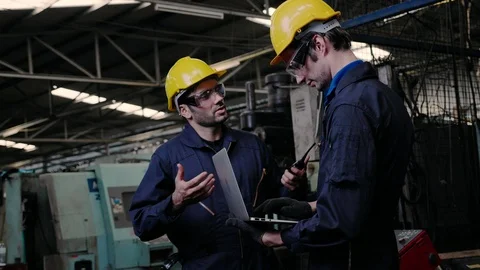 Two Engineer worker wears a yellow safety helmet, discusses the work Stock Footage 124741478