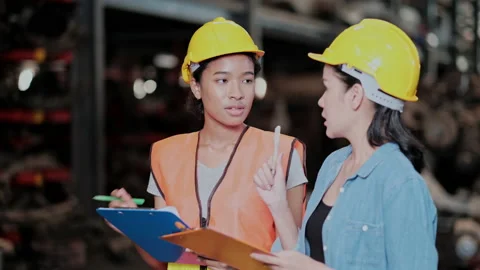 Two engineer workers discuss on job in the engine part factory Stock Footage 142523611