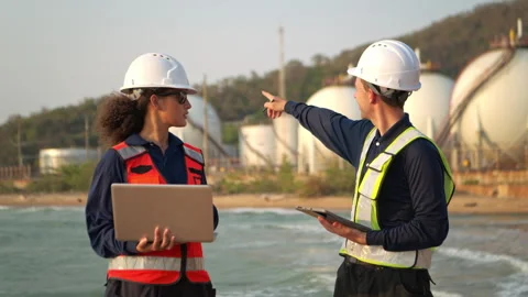 Two engineering at an oil refinery discussing operations and planning Stock Footage 340084989