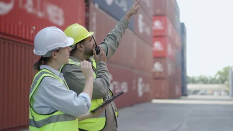 Two engineering people discussing inventory lists while record data with tablet Stock Footage 313716963