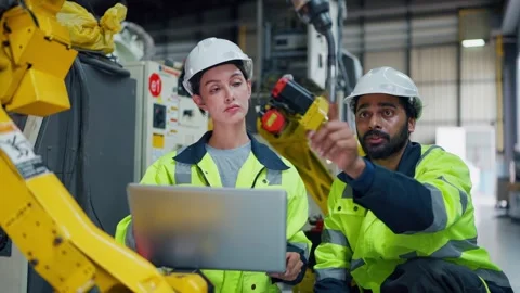 Two engineers analyze data on a laptop together Stockbeeldmateriaal 347352295