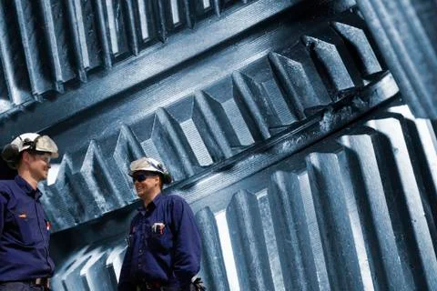 Two engineers and metal cogs Stock Illustration